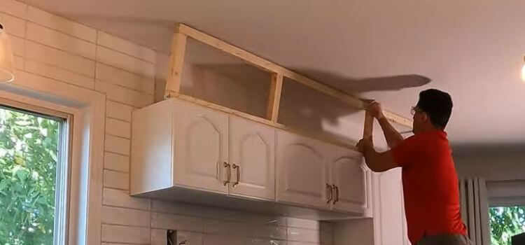 Attach the blocks to the tops of the cabinets and the ceiling