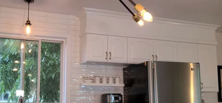 Paint the panel and cabinets the same color